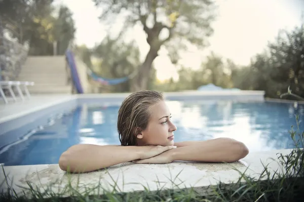 relaxed-woman-resting-at-poolside-in-summer-377108