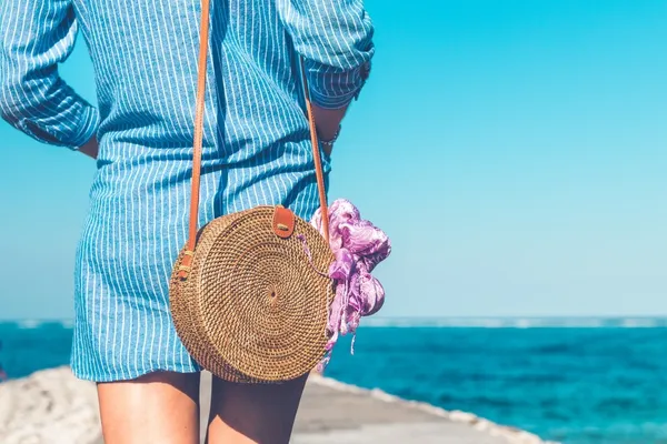woman-wearing-blue-and-white-striped-dress-with-br