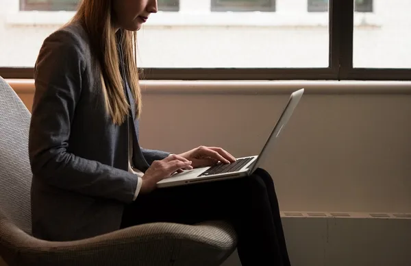 woman-sits-and-use-laptop-computer-near-window_118