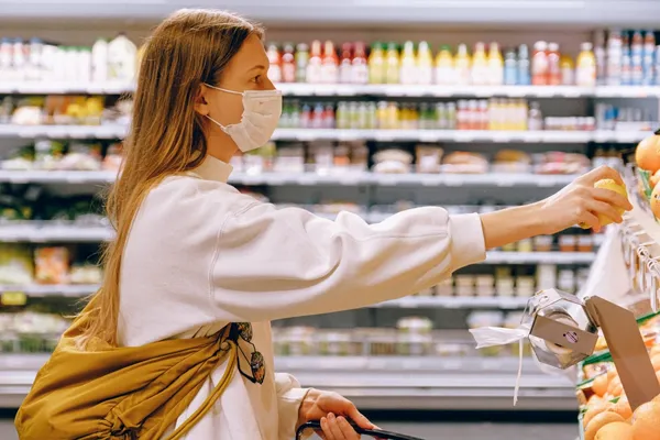 woman-wearing-mask-in-supermarket-3962289-scaled.j