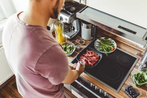 young-man-cooking-raw-meat-grill-pan5.jpg