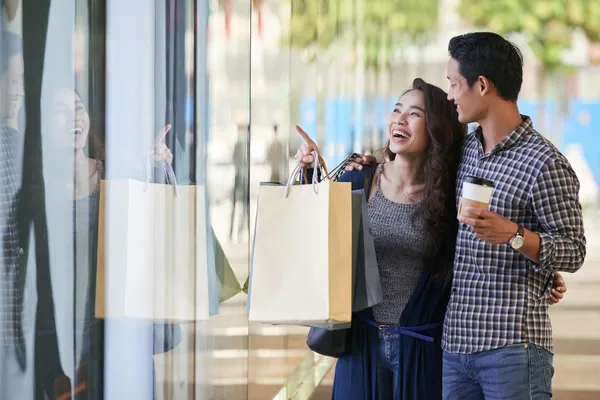 sale-carefree-couple-window-shopping-clothes-store