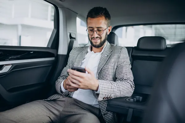 business-man-sitting-back-sit-car-using-tablet