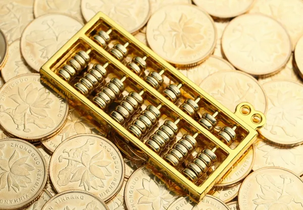 golden-abacus-with-chinese-rmb-gold-coins-as-backg