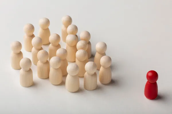 差異化人才：木製人偶群中的紅色人偶